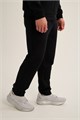 Купить оптом Брюки трикотажные удлиненные Anta TRN-ESSENTIAL Knit Track Брюки 852647310LC-1 852647310LC-1